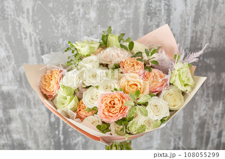 Floral shop concept. Small Beautiful bouquet of mixed flowers. Beautiful fresh cut bouquet. Flowers delivery Floral shop concept. Small Beautiful bouquet of mixed flowers. Beautiful fresh cut bouquet. Flowers delivery 108055299