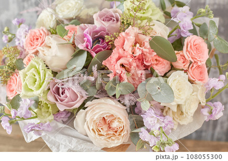 Small Beautiful bouquet of mixed flowers in woman hand. Floral shop concept . Beautiful fresh cut bouquet. Flowers delivery 108055300