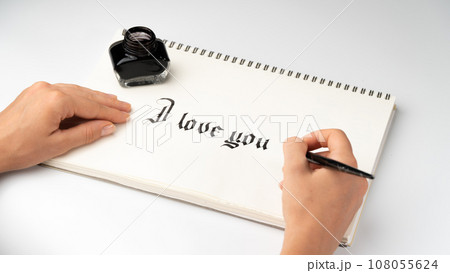 Women's hands write I love you fountain pen for calligraphy Women's hands write I love you fountain pen for calligraphy 108055624