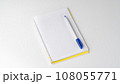 Checkered notebook with pen on white background, space for inscription 108055771