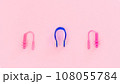 Swimmer set - earplugs and nose clip on pink background close-up 108055784