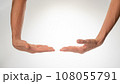 Women's hands insulated hold a large object on a white background 108055791