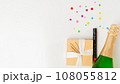 New Year's set - a gift, champagne and a cracker on a white background with a place for text 108055812