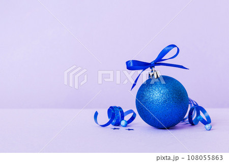 Christmas ball on colored background. decoration bauble with ribbon bow with copy space 108055863