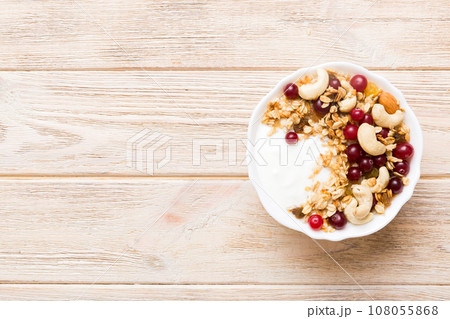 Healthy breakfast food with granola, yogurt, fruits and nuts. Dessert parfait with dried fruits for breakfast Healthy breakfast food with granola, yogurt, fruits and nuts. Dessert parfait with dried fruits for breakfast 108055868