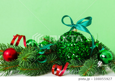 New Year Christmas tree toy, branches of a christmas tree, New Year decorations on a colored background 108055927