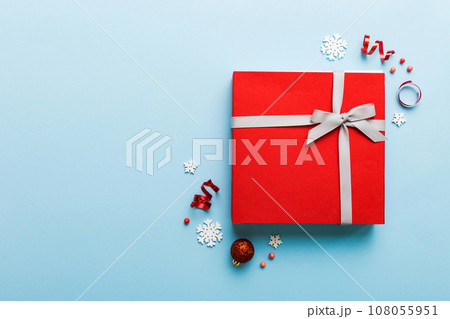 Top view Flat lay Christmas decorations and gift box on colored background with copy space. Christmas or Happy New Year composition Top view Flat lay Christmas decorations and gift box on colored background with copy space. Christmas or Happy New Year composition 108055951