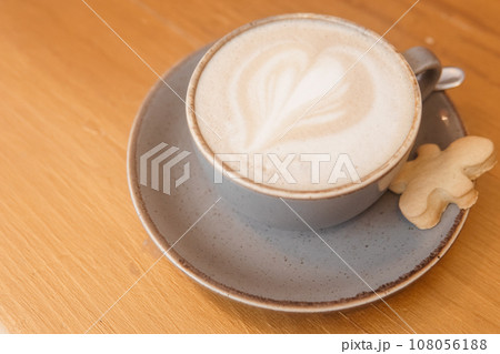 Coffee on a wooden table in a cafe, drawings on coffee. 108056188