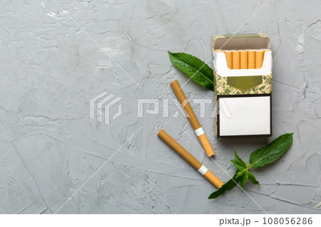Pack of menthol cigarettes and fresh mint on colored table, Menthol cigarettes top view flat lay 108056286