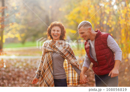 smiling stylish boyfriend and girlfriend in park walking smiling stylish boyfriend and girlfriend in park walking 108056819