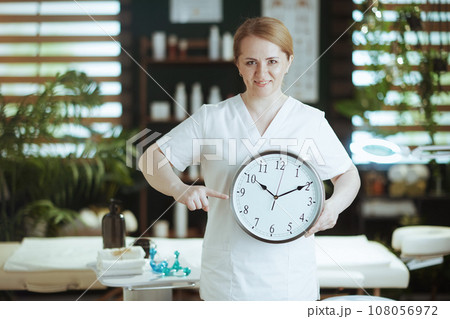 smiling female medical massage therapist in massage cabinet 108056972