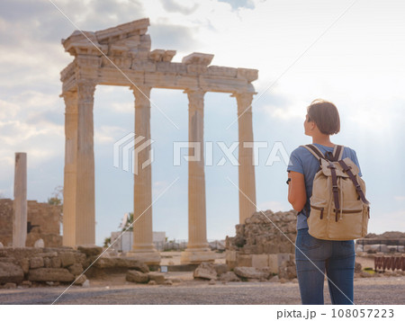 travel to ancient city of Side, Antalya coast of Turkey in tourist low season. Young tourist Asian woman is posing in front of temple of Apollo 108057223