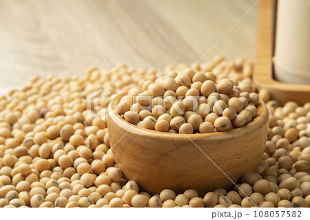 Soybean seeds in wooden bowl on wood table 108057582