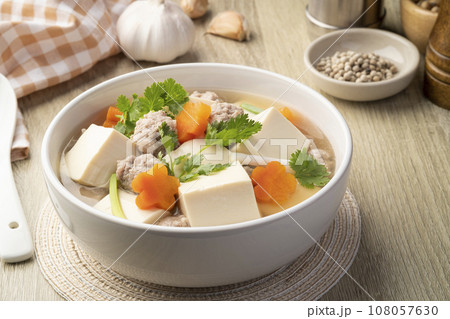 Clear soup with soft soy bean curd ,Minced Pork and Vegetables in white bowl 108057630