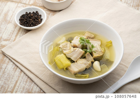 Preserved mustard green with pork belly soup in white bowl 108057648