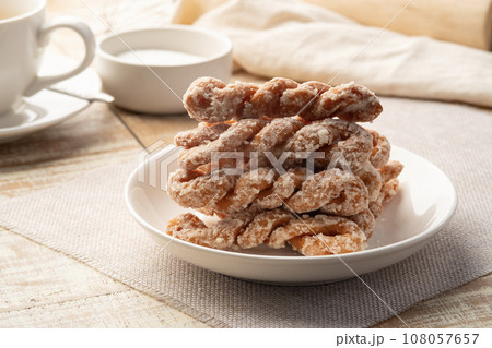 Puffy Twist Donut,mildly sweet and fluffy,twisted sugar doughnuts in white plate Puffy Twist Donut,mildly sweet and fluffy,twisted sugar doughnuts in white plate 108057657