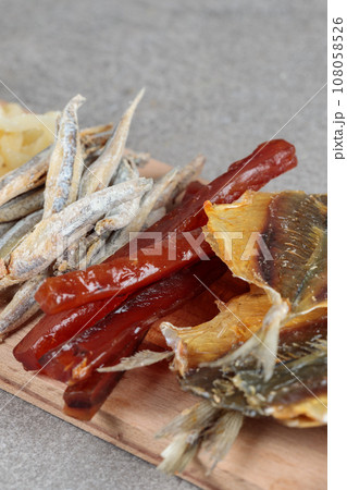 Fish snacks on a wooden board close-up. Fish snacks on a wooden board close-up. 108058526