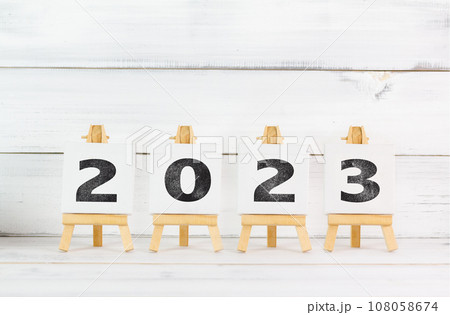 Upcoming 2023 New Year with Art Board over white wood background. 108058674
