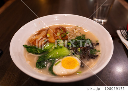 Tonkotsu ramen with soft Pork Belly ,boiled egg and baby bok choy Tonkotsu ramen with soft Pork Belly ,boiled egg and baby bok choy 108059175