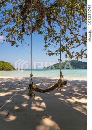 Wooden swing on beautiful white sand beach, Surin island national park, Phang nga, Thailand Wooden swing on beautiful white sand beach, Surin island national park, Phang nga, Thailand 108059743