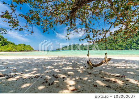 Wooden swing on beautiful white sand beach, Surin island national park, Phang nga, Thailand Wooden swing on beautiful white sand beach, Surin island national park, Phang nga, Thailand 108060637