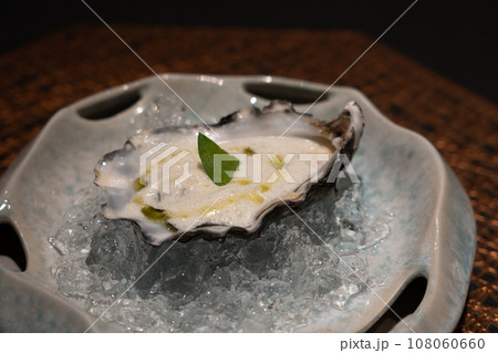 Fresh oyster with foam sauce and wasabi oil Fresh oyster with foam sauce and wasabi oil 108060660