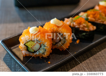 California maki with crab stick and tobiko California maki with crab stick and tobiko 108060773