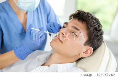 Facial injection male patient Facial injection male patient 108061267