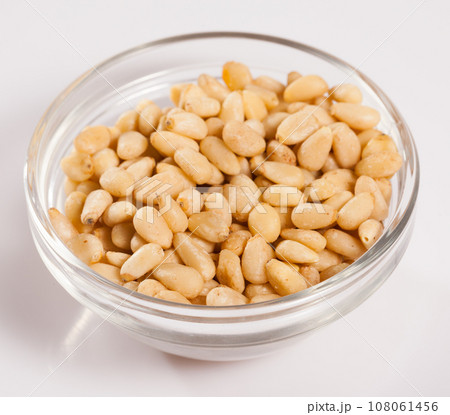 Pile of delicious pine nuts on a white surface 108061456