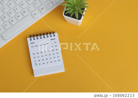 March 2024 desk calendar on yellow background. Directly above. Flat lay. 108062213