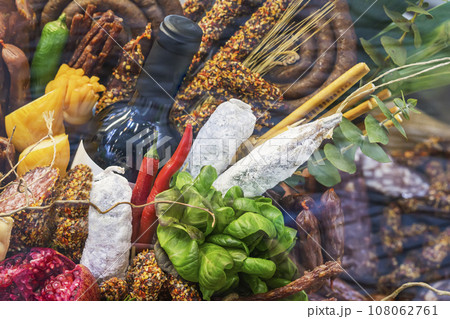 Food Showcase of delicatessen on Market, assortment of sausages and meat prepared products, cheese, fruit, wine 108062761