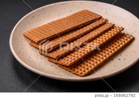 Delicious sweet crispy rectangular waffles on a ceramic plate 108062792
