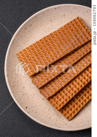 Delicious sweet crispy rectangular waffles on a ceramic plate Delicious sweet crispy rectangular waffles on a ceramic plate 108062793