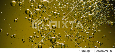 Golden Hyaluron Oil bubbles collagen serum or yellow oil bubbles drop texture background. Liquid transparent droplets. Skincare essential product with dribs. Honey syrup bubble. Oil droplets close up Golden Hyaluron Oil bubbles collagen serum or yellow oil bubbles drop texture background. Liquid transparent droplets. Skincare essential product with dribs. Honey syrup bubble. Oil droplets close up 108062910