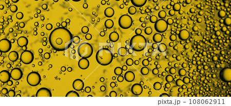 Golden Hyaluron Oil bubbles collagen serum or yellow oil bubbles drop texture background. Liquid transparent droplets. Skincare essential product with dribs. Honey syrup bubble. Oil droplets close up Golden Hyaluron Oil bubbles collagen serum or yellow oil bubbles drop texture background. Liquid transparent droplets. Skincare essential product with dribs. Honey syrup bubble. Oil droplets close up 108062911