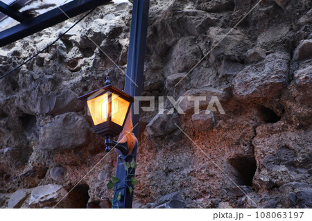 stained-glass wall lamp on a stone wall stained-glass wall lamp on a stone wall 108063197