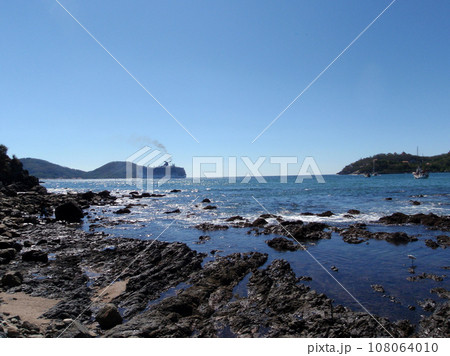 Bay of Zihuatanejo with bird playing in shore and Cruiseship in the background Bay of Zihuatanejo with bird playing in shore and Cruiseship in the background 108064010