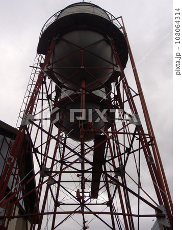 Two water towers against a dark sky Two water towers against a dark sky 108064314