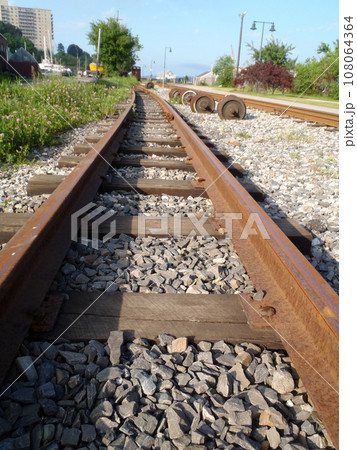 Railroad tracks running into distance with through Portland, Maine 108064364