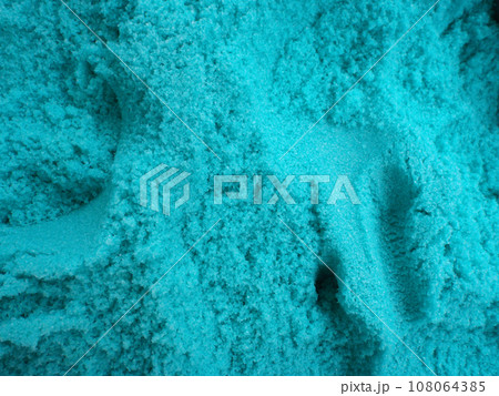 large amount of blue bath salt with scoop holes in it 108064385