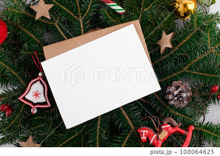 Christmas 5x7 card mockup template with envelop on natural fir branch background 108064625