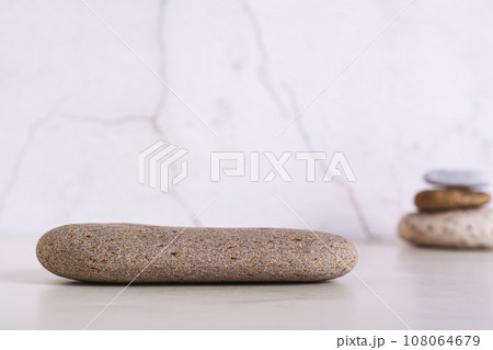 Pattern of smooth flat sea stone pedestal on table Pattern of smooth flat sea stone pedestal on table 108064679