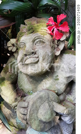Beautiful artistic Bali stone statue of a Balinese ancient garden statue used as garden decoration, javanese gnome indonesia 108071409