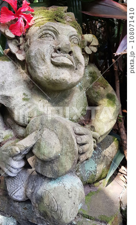 Beautiful artistic Bali stone statue of a Balinese ancient garden statue used as garden decoration, javanese gnome indonesia Beautiful artistic Bali stone statue of a Balinese ancient garden statue used as garden decoration, javanese gnome indonesia 108071410