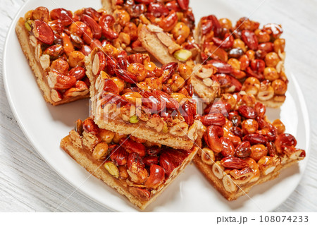 toffee mixed nuts shortbread bars on white plate 108074233