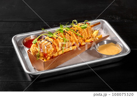 Classic sausage corn dog with french fries, sweet chili and cheddar sauces 108075320