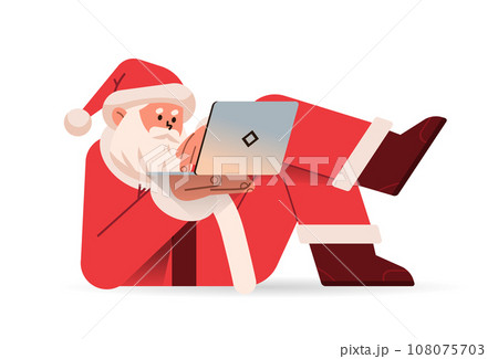 santa claus in red costume lying on his back and typing on laptop happy new year merry christmas holidays celebration concept santa claus in red costume lying on his back and typing on laptop happy new year merry christmas holidays celebration concept 108075703
