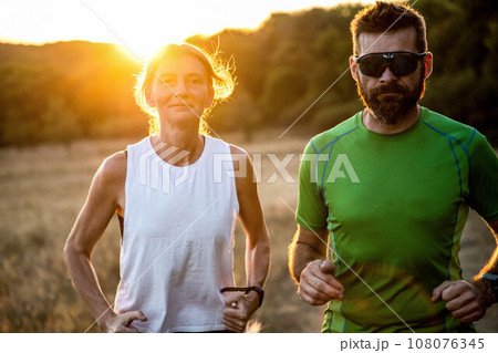 fit couple running with dog fit couple running with dog 108076345