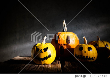 scary funny Halloween pumpkins on wooden table 108076346