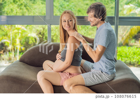 health, pregnancy and happy people concept - husband giving his wife back massage at home health, pregnancy and happy people concept - husband giving his wife back massage at home 108076615